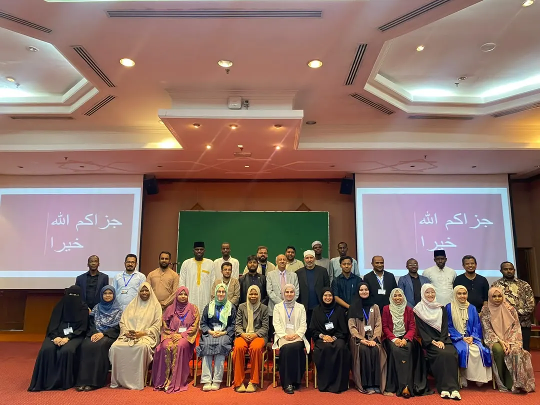 Participants gathered together at the front of a seminar room.